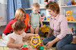 two mothers and children in playroom