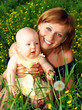 smiling mother and baby  in the park.