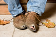 Worn and battered shoes of a beggar in the streets Worn and battered shoes of a beggar in the streets