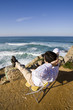 Man sit, enjoying the Ocean view