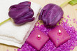 Spa essentials (candles, towel, salt and violet flowers)