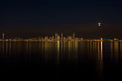 Seattle skyline at night with the moon appearing from a cloud
