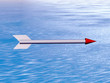 the grey arrow with red tip is flying above ocean
