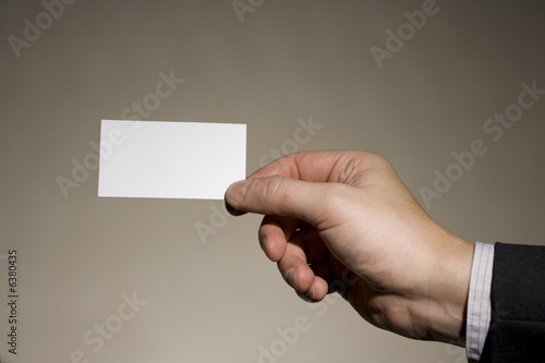 Photo: a businessman holding a business card 1 a businessman holding a business card 1