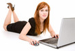 Young Redhead Lady Relaxing and Using Laptop