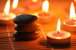 Pebbles and burning candles for aromatherapy session