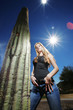 Hot girl in Arizona standing next to a huge Saguaro Cactus.