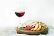 wine cheese bread and fruits on white