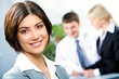Face of beautiful woman on background of business people