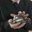 man senior hoding a piggy bank