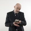 man senior hoding a piggy bank