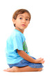 Kneeling boy looking at the side on white .