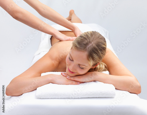 Portrait of a pretty young girl getting a massage at the day spa