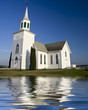 Old white church set against a dark blue sky