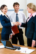 Image of confident business people shaking hands Image of confident business people shaking hands