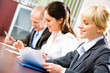 Image of confident students sitting at the desk Image of confident students sitting at the desk