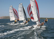 Photo: Dynamic racing dinghies sailing away Dynamic racing dinghies sailing away