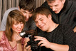 four young smiley men and women with photocamera