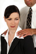A man sexually harassing a coworker