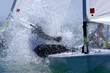 Foto: Sailors splash through the waves during a regatta. Sailors splash through the waves during a regatta.