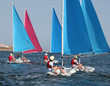 Photo: Children sailing small boats, following their instructor Children sailing small boats, following their instructor