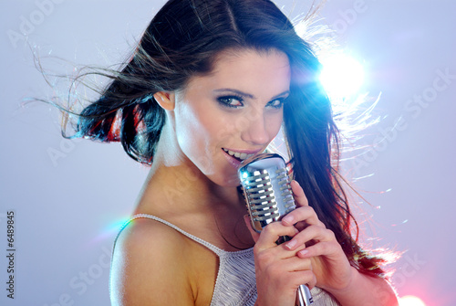Photo: Rock star. Young woman with retro music micropone Rock star. Young woman with retro music micropone