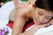 A young woman enjoying a massage outside