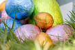 Easter eggs spilling out of a bucket onto grass