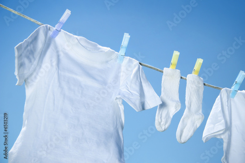 Eco friendly  laundry drying on clothes line against a blue sky 