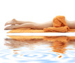 long legs of relaxed lady with orange towel on white sand #3