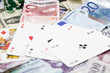 Poker hands - cards have focus with poker chips and money