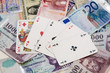 Poker hands - cards have focus with poker chips and money
