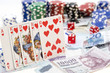Poker hands - cards have focus with poker chips and money