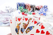 Poker hands - cards have focus with poker chips and money