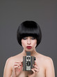 Woman using a vintage camera