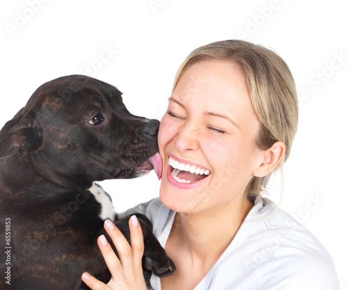 Young woman and sweet puppy playing around