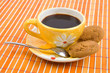 Cookies and cup with cofee on bamboo table-cloth