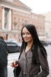 Young woman with music player walking in a street