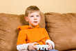 Happy young boy playing video game