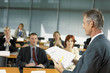Businesspeople being lectured