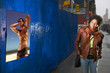 Woman looking at poster of bare chested man Woman looking at poster of bare chested man