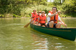 Family wearing life jacket in canoe