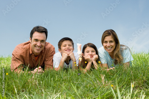 Family lying on meadow
