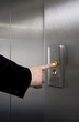 Man pressing elevator button