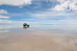 jeep in the salt lake salar de uyuni, bolivia