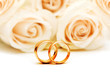 Roses and wedding rings isolated on the white