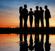 silhouette business team. sunset water
