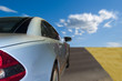 Silver sports car driving fast on the highway Silver sports car driving fast on the highway