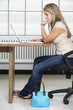 Side view of a teen girl working on a laptop.