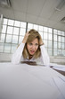 A depressed business woman looking at papers.